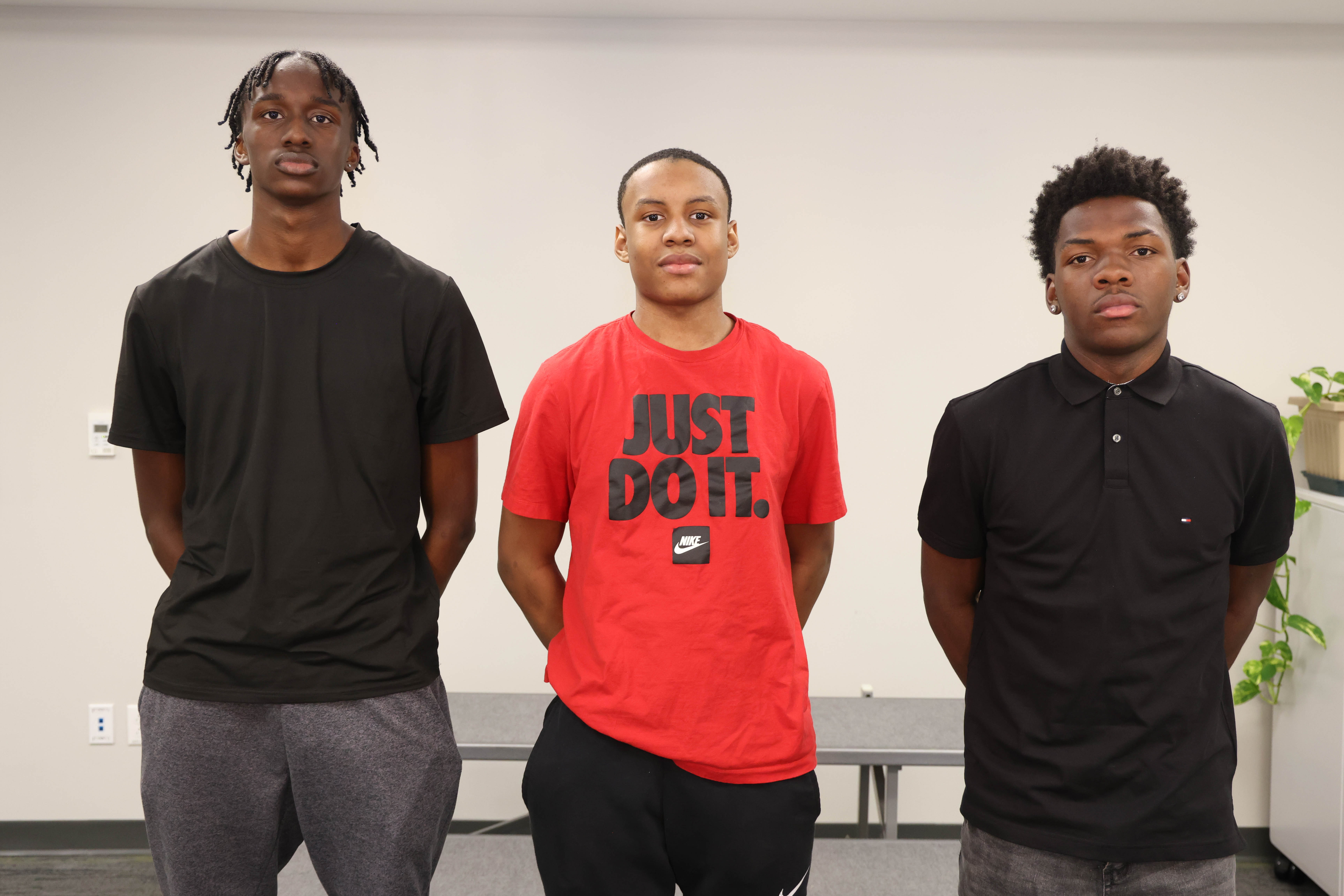 Three boys basketball players are shown